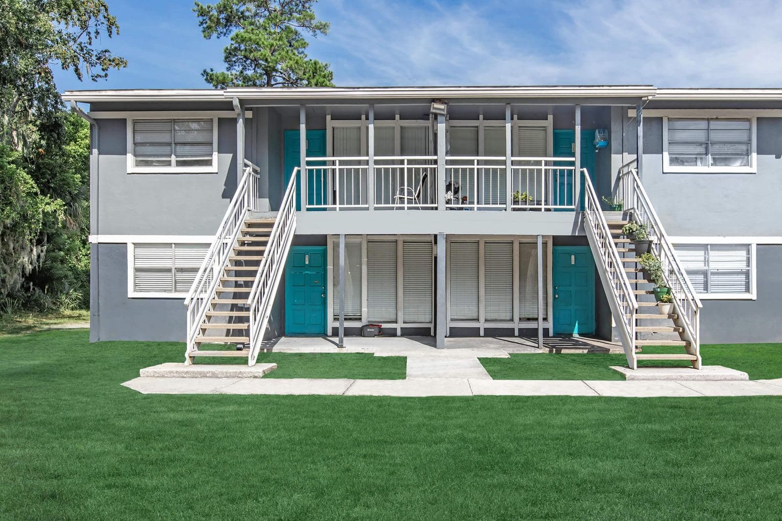 The same style of Jacksonville apartment building after repositioning: new paint, new stairs, new landscaping