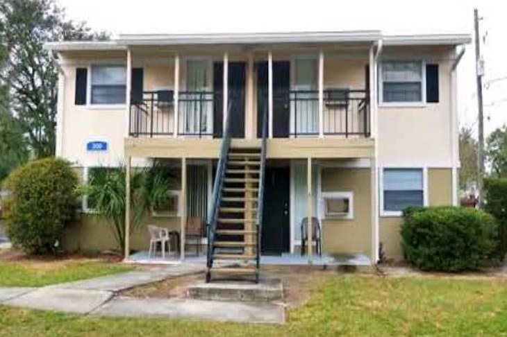 Jacksonville apartment building before repositioning: worn paint, window units, dated exterior